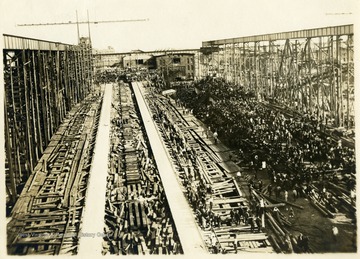 A crowd disperses after the launching of the battleship.