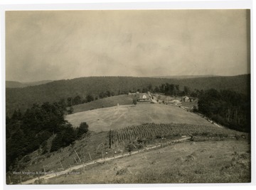 Farmhouse and the surrounding fields and garden of a ridgetop home. U.S. Dept. of Agriculture, Bureau of Agricultural Economics, Photographic Section, Number 18411.