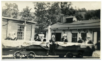 Group of people with helmets on in mine cars getting ready to go on a tour of the Hutchinson Family Mine near Fairmont, W. Va. 