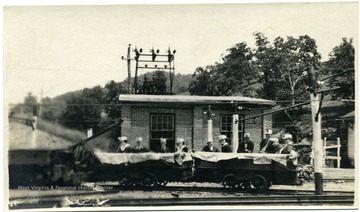 Group of people in coal cars outside of the Hutchinson Family Mine near Fairmont, W. Va. 