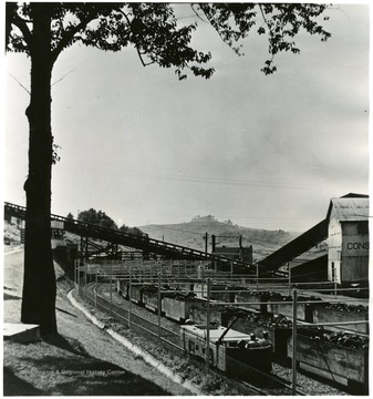 Vandivert No. 32 J-33, 5-9. August 1948. View of safety-fenced mine car unloading yard and personnel overpass, Consolidation Coal Company, Fairmont, W. Va. Bituminous Coal Institute. Feb 1950. 320 Southern BLDG, Washington 5, D.C.