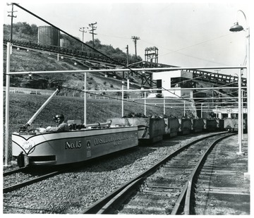 Electric Locomotive No. 15 pulling coal through yard at Consol Mine No. 32 in W. Va. Bituminous Coal Institute, Aug, 1948, 320 Southern Bldg., Washington 5, D.C.