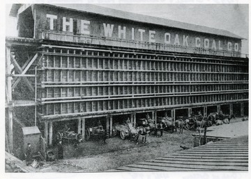 Horse drawn carts emerging from the White Oak Coal Company Storage and Distributing Plant at Richmond, Virginia.