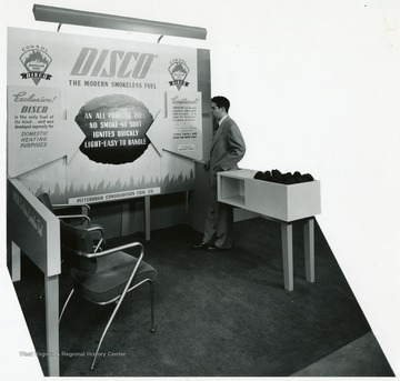 A man stands next to the Disco Fuel exhibit.
