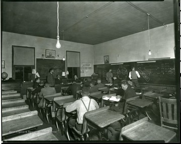 Early Mining Extension class being taught by U.G. Carter in Logan County, 1938-1940.