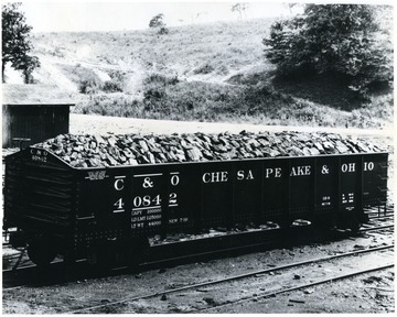 Caption on back reads, 'When better coal is prepared, White Oak will load and prepare it. We are proud of this picture of a car of "White Oak" Lump coal. This picture was also taken without the knowledge of the White Oak employees who loaded it. If you drive past any of the White Oak Mines on U.S. Highway 19-21, in Fayette County, W. Va., you will see many just like it.'