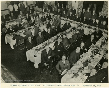 Lewis is seated at the table on the right.