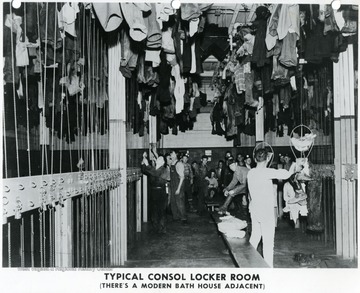 Miners gathered in a typical Consol locker room with a modern bath house adjacent to it. 