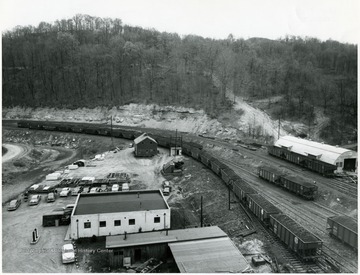 Coal cars run down the track in a preparation plant yard.