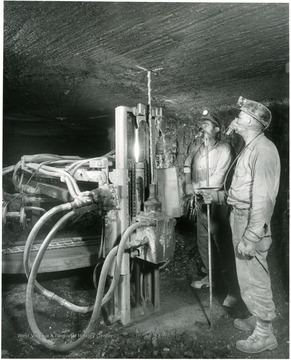 Two men running a roof bolter in Jamison No. 9 mine.