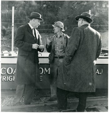 Miner talking with two coal officials during a Consolidation Coal Co. Inspection trip.