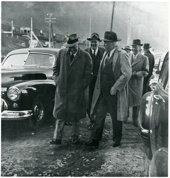 Coal officials walking between cars during a Consolidation Coal Co. Inspection trip.
