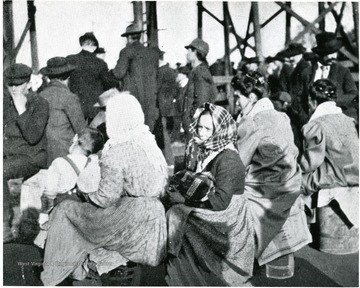 Wives and other family members waiting outside Monongah Mine No. 8 for information regarding if their husbands and/or sons are dead or alive.  A.G. Martin & Company.