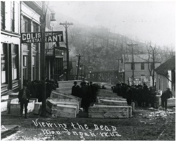Men lined up to view the caskets in the streets of Monongah.