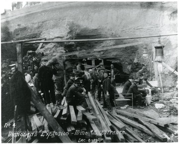 Men sitting and standing near the entrance to mine no. 8.