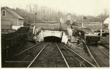 Tracks lead to the entrance of an underground coal mine in Thomas, W. Va.  Carts on tracks to the left of the entrance.