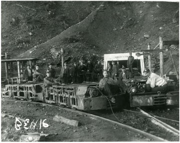 Miners on cars in front of the entrance to the Bergoo No. 3 Mine. Rear Left to Right:  Ernest 'Windy' Rose, Argil Rose (on car), Oliver Williams, French Dunlop, Ernie Riffle (later killed in a mine accident at the same mines), Mike Hamilton, Hartsel Friend, Lloyd Crites, Fred Bennett?, Russell Heaveners; Motor Men: Bucky Rexroad (left) and Okey Grien (right), Gordon Ward (2nd motor left) and Gillepsie (2nd motor right), Hick Hardway (standing on car), Ray Riffle (leaning on car).