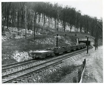 A miner operates a full coal cart down the track coming from Mathies Mine.