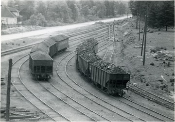 Loaded railroad cars on the tracks at Skelton show the famous White Oak Smokeless Coal.
