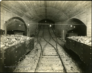 Coal carts on tracks and corridor openings in an underground mine in Monongalia County.