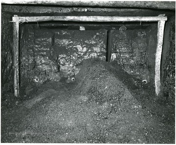 Notice the preparatory cut and the 3 charge-holes near floor of the mine.