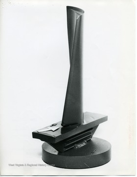 This mock-up shows the new blade design being tested by the Bureau of Mines. The base of the blade is thicker and there is a strip of titanium carbide at the point of previous severe erosion. If used, please credit Bureau of Mines, U.S. Department of the Interior.During LDC's final 1,100-hour run, this rotor blade (arrow) was undercut by ash flowing  along the rotor past the tips of the stator blades. If used, please credit Bureau of Mines, U.S. Department of the Interior.