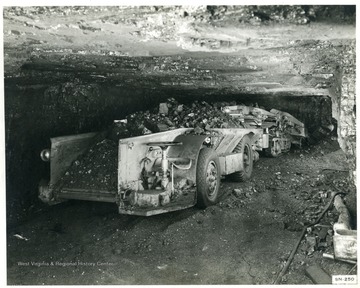Rear end of loaded coal car in an underground mine.