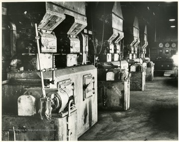 View of a row of boilers and equipment in an underground mine.