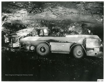 Shuttle car in an underground mine, loaded with coal.
