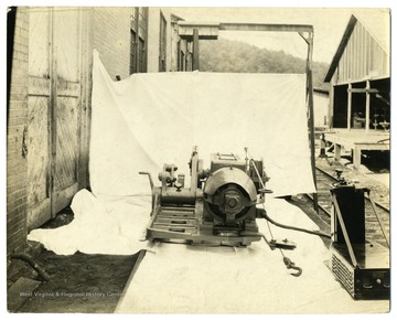 Machinery outside sitting on a white sheet.