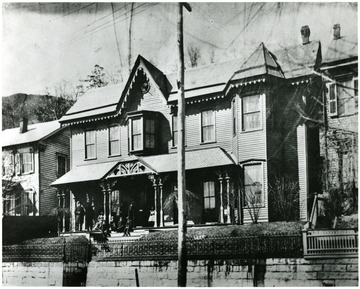 Justus C. Beury and family on porch.