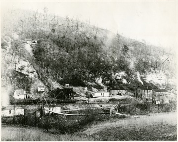 View of town with railroad going past miners houses.