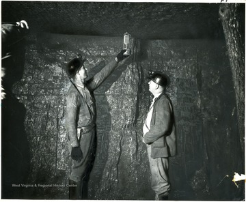 Two miners test for gas in mine. Hamilton Wright Organization Inc.  80 Rockefeller Plaza, New York City, 'Newspaper Feature News' This photograph released to you GRATIS for editorial use only. Do not use for advertising purpose without written permission.
