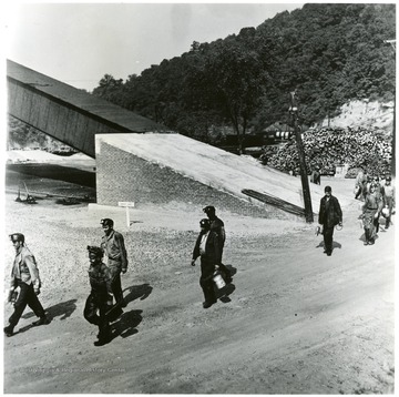 'Miners walking from slope entry in background toward wash house at end of shift. Mine No. 98, Consolidation Coal Co. W. Va.'