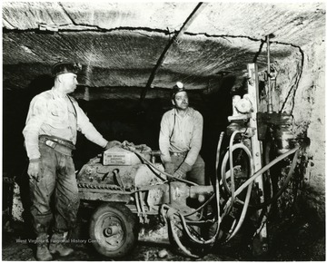 Two miners put bolts in to the mine rood at Jamison No. 9.