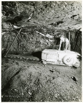 Miner using a very small cutting machine.