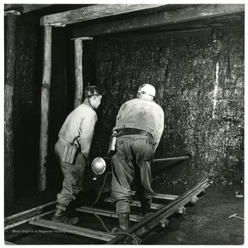 Miners use large drill to place charges in holes deep in the coal. 'William Vandivert, Not to be reproduced without written liscense.'