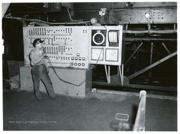 Miner speaking in microphone at control board at Jamison No. 9.