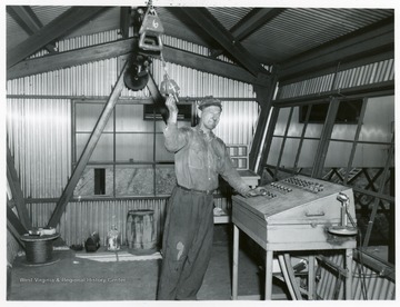 Miner at control board at Jamison No. 9.