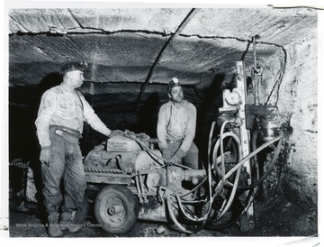 Two miners work with a Joy roof bolt drill at Jamison No. 9.