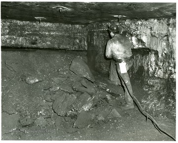 Miner drilling a hole for explosives at the Bishop Mine, Pocahontas Fuel Co.