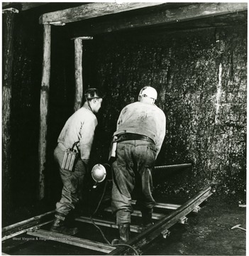 Miners drill two or more holes into coal to place the explosive charges.