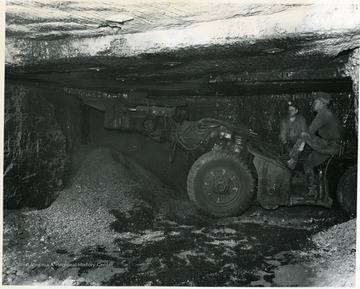 Two miners work with a cutting machine at Pursglove No. 15.