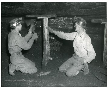 Two miners working to support the roof in the Itmann Coal Co. mine. <br /><br />
