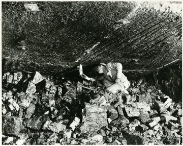 This miner is mostly likely testing for gas  in the Bethlehem Mine at Barrackville.
