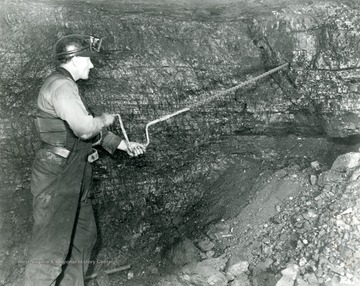 Miner Drilling a hole in mine.