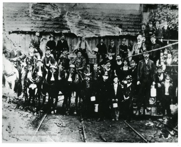 Group portrait of miners, where five of them are on horses.  John Williams, Coal Life Project