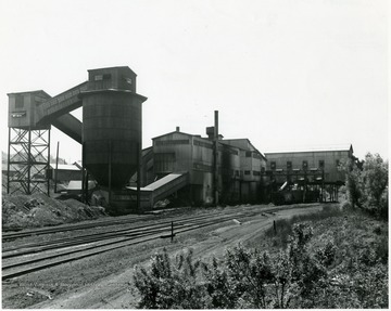 A processing plant with adjacent railroad tracks.