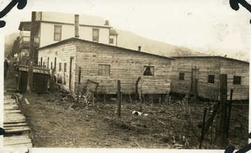 Barracks at Lost Creek with a house in the background.