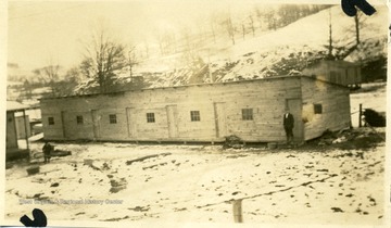 Man standing outside of barracks at Bear Mountain, W. Va.